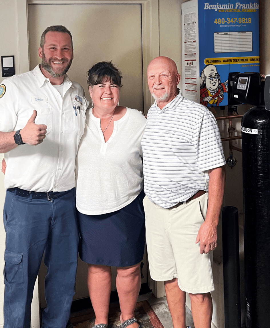 Benjamin Franklin Plumbing technician with satisfied Phoenix homeowners
