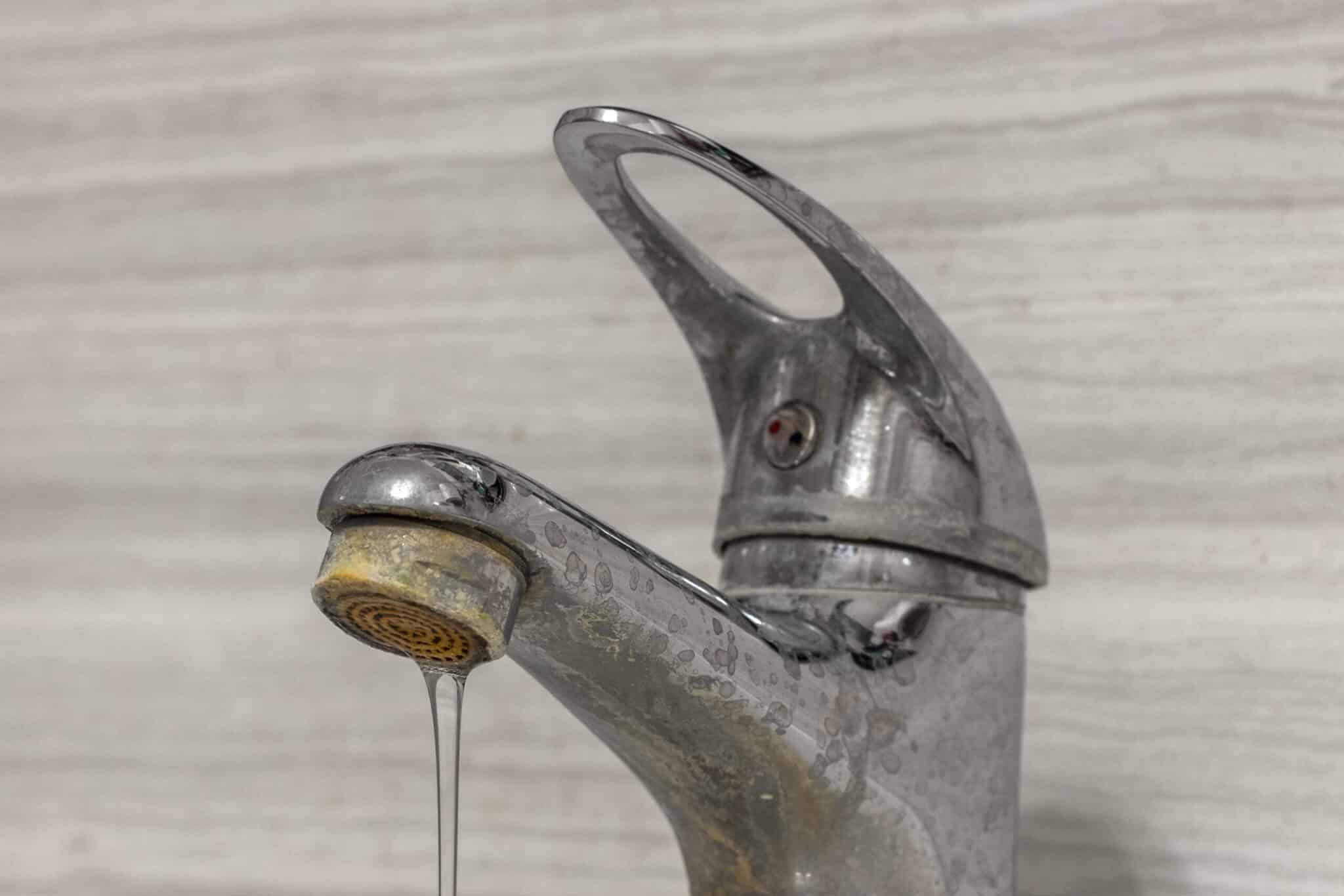 Hard Water Flows on Old Tap.